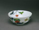 Image from above of white porcelain bowl with flowers and vegetal motifs in blue, green and red…