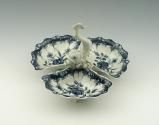 Blue and white porcelain tray with three containers and white fish, top view