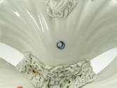 Close view of bottom of blue and white porcelain tray with three containers and white fish