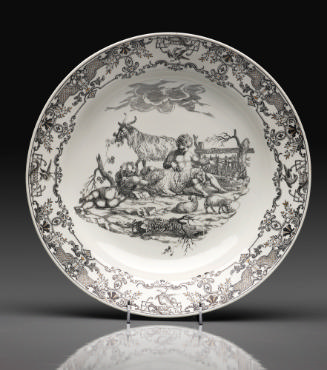 White porcelain plate decorated with a black and white scene of a nude boy in a landscape surro…