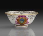 White porcelain slop bowl with gilded rim decorated with an armorial crest in blue, green and p…