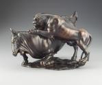 Alternate view of a bronze sculpture of a leopard attacking a bull.  The leopard is actively cl…