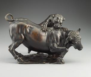 Bronze sculpture of a leopard attacking a bull.  The leopard is actively clawing and biting the…