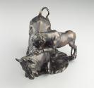 Alternate view of a bronze sculpture of a leopard attacking a bull.  The leopard is actively cl…