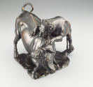 Alternate view of a bronze sculpture of a leopard attacking a bull.  The leopard is actively cl…